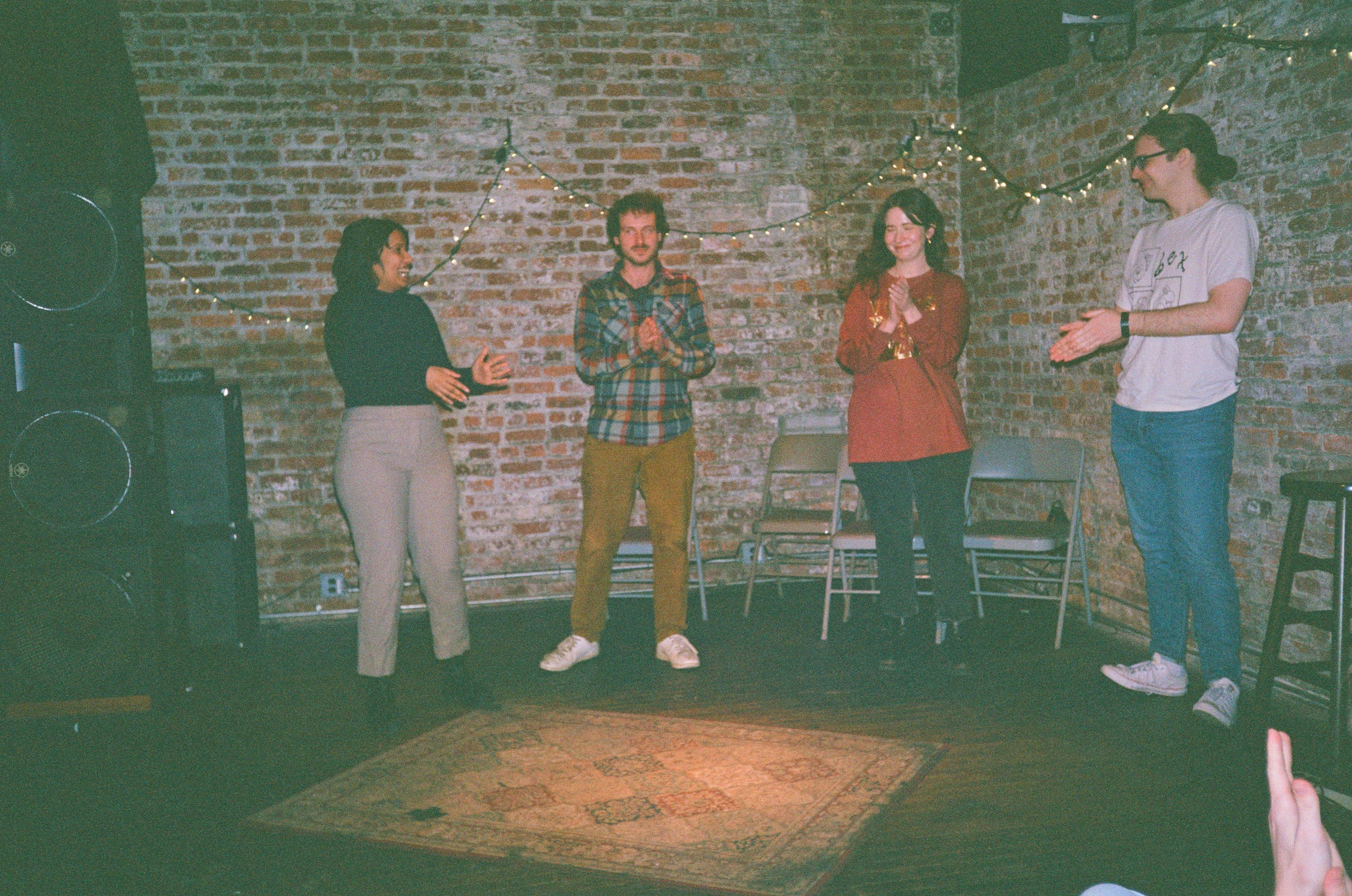 film photograph of beev awkwardly clapping on stage