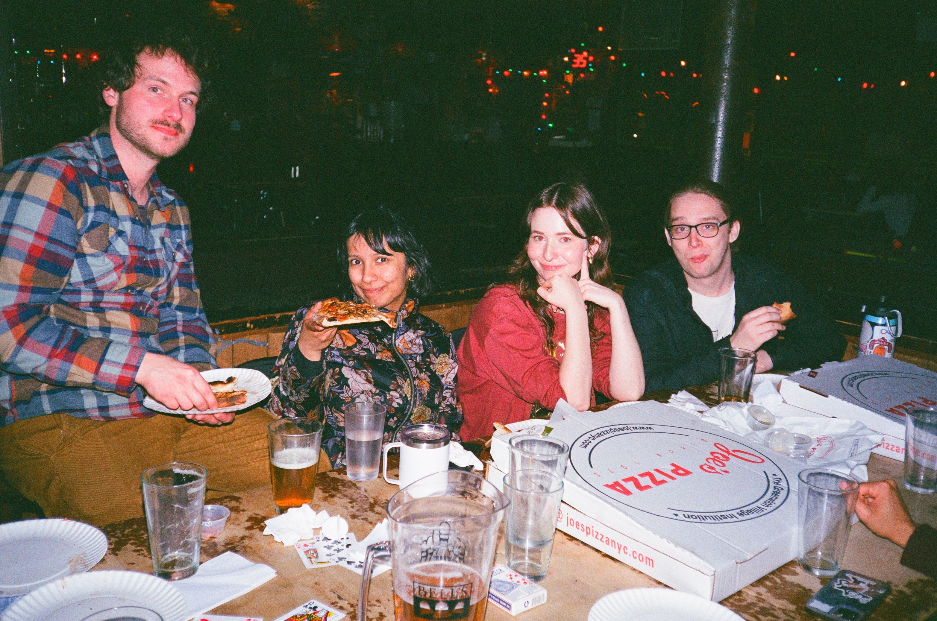 flash film photograph of beev eating pizza and boy does it look greasy